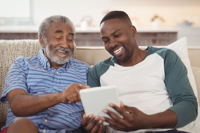 Two men reading a tablet